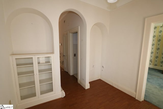 hallway with dark hardwood / wood-style floors