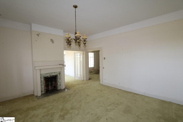 unfurnished living room with carpet flooring, an inviting chandelier, and a tiled fireplace