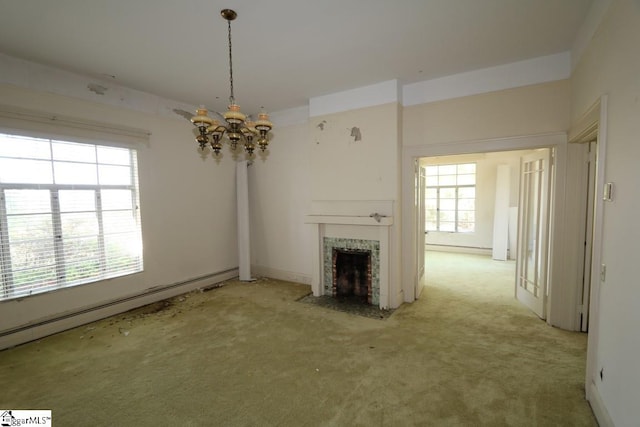 unfurnished living room with a baseboard heating unit, carpet, and an inviting chandelier