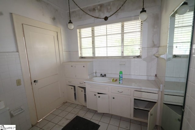 bathroom featuring tile floors, vanity, backsplash, and tile walls