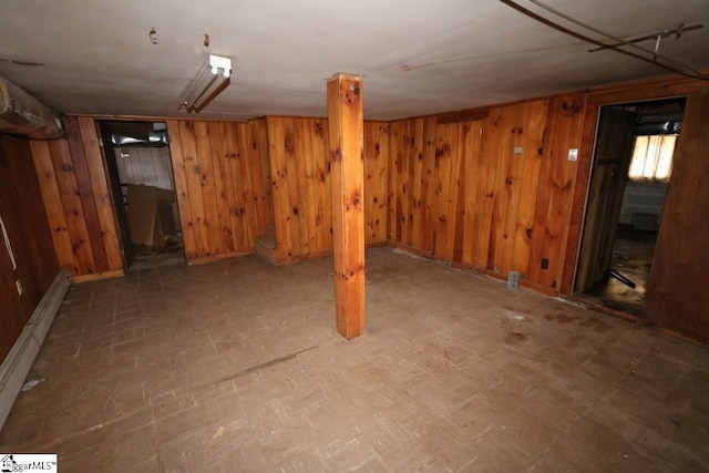 basement featuring wooden walls