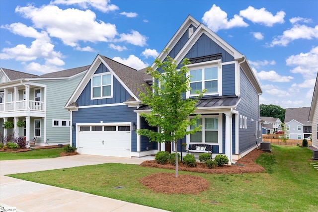 craftsman-style home featuring a garage, a front lawn, a balcony, and central air condition unit