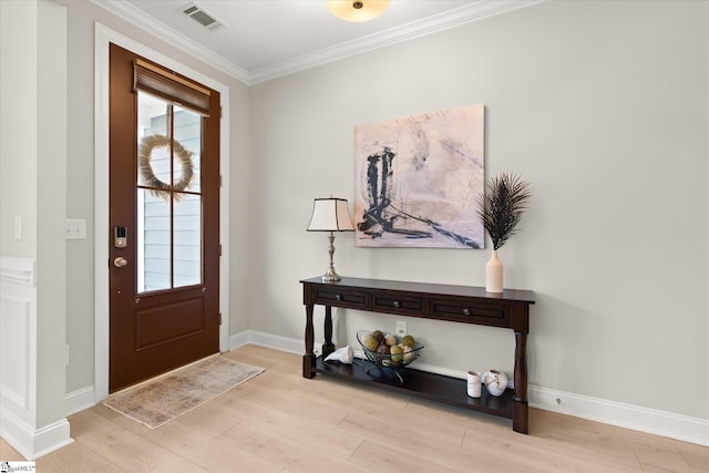 foyer featuring crown molding and light wood-type flooring