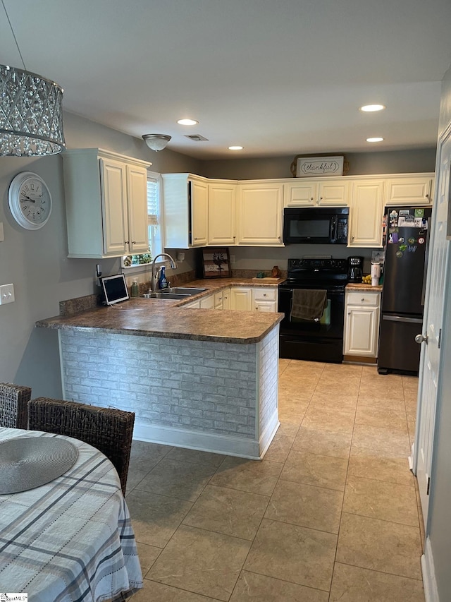 kitchen featuring sink, black appliances, light tile floors, and kitchen peninsula