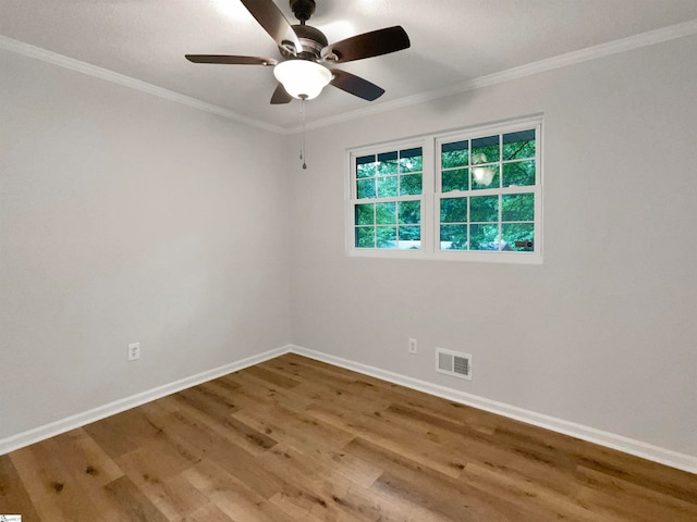 unfurnished room with hardwood / wood-style floors, ceiling fan, and crown molding