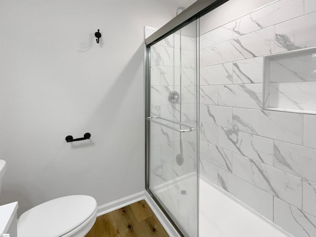 bathroom featuring an enclosed shower, wood-type flooring, vanity, and toilet