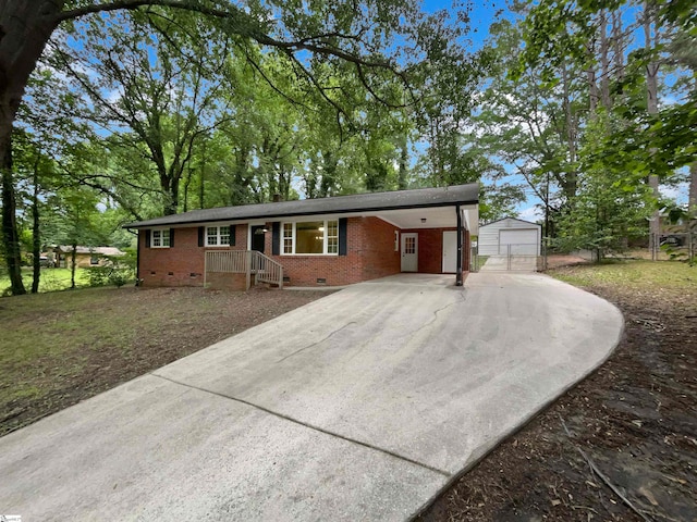 single story home with a carport, a garage, and an outdoor structure