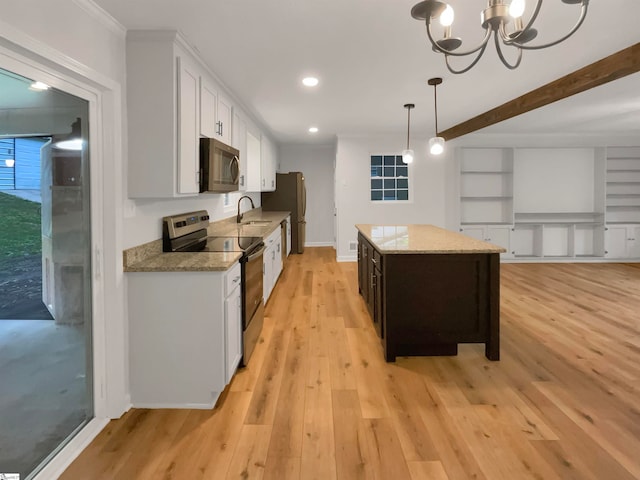 kitchen with a center island, light hardwood / wood-style floors, stainless steel appliances, decorative light fixtures, and a notable chandelier