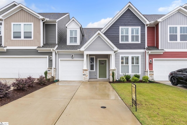 view of property featuring a garage and a front lawn