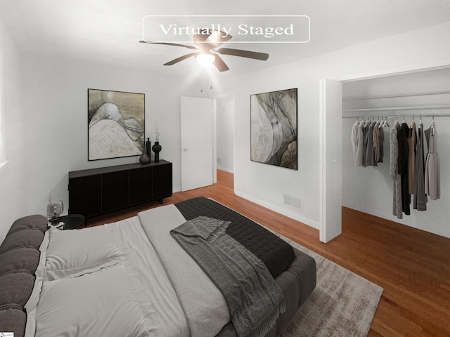 bedroom featuring wood-type flooring, a closet, and ceiling fan