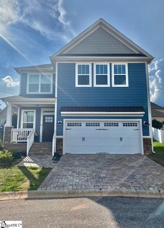 view of front of home with a garage and covered porch