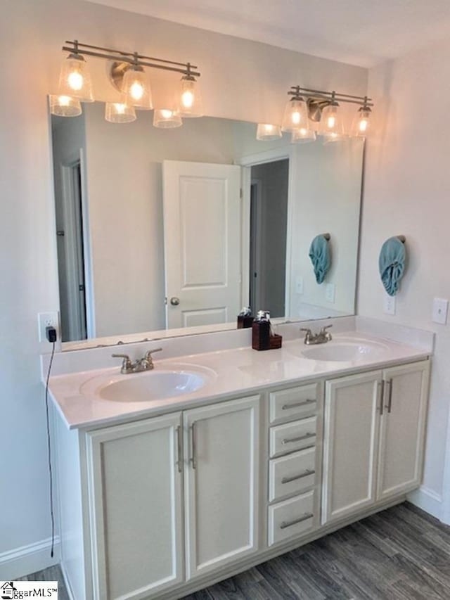 bathroom featuring dual vanity and hardwood / wood-style floors