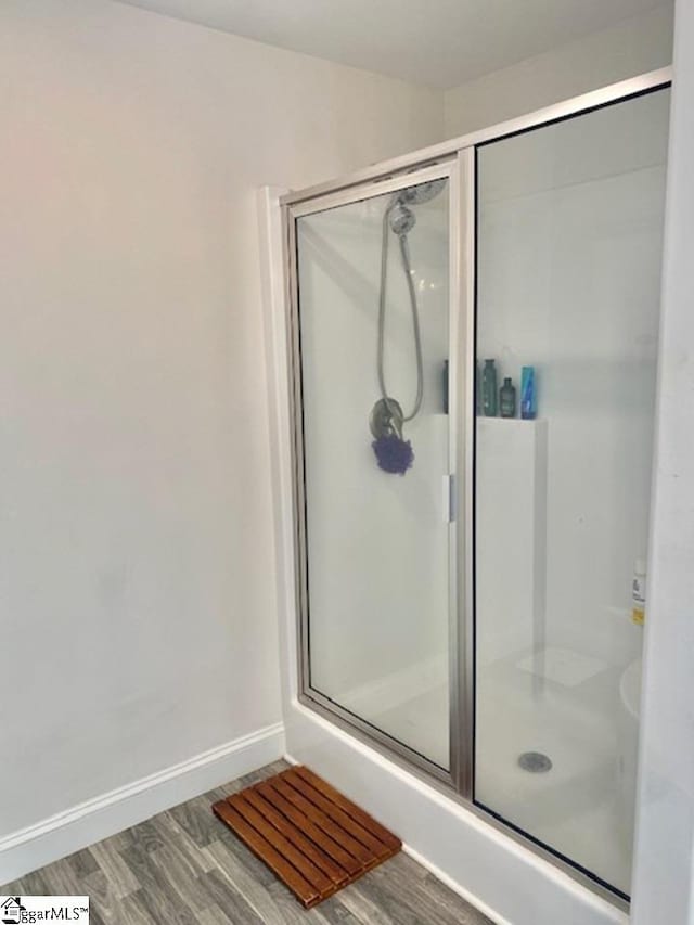 bathroom featuring walk in shower and hardwood / wood-style floors