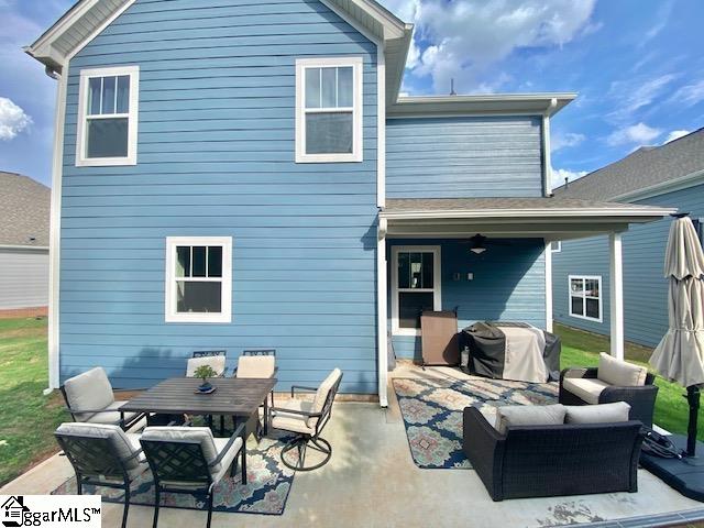back of house featuring a patio area and outdoor lounge area