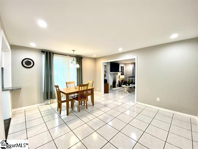 dining space featuring light tile floors