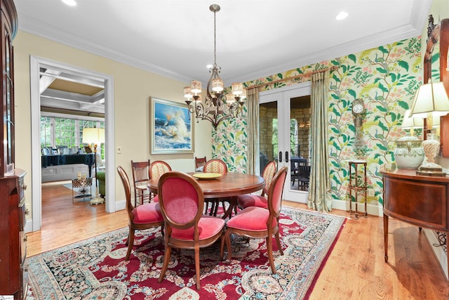 dining room with light hardwood / wood-style flooring, an inviting chandelier, french doors, and ornamental molding