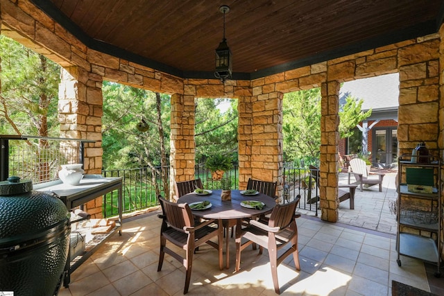 sunroom / solarium featuring wood ceiling