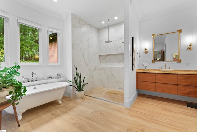 bathroom with hardwood / wood-style floors, vanity, crown molding, and plus walk in shower