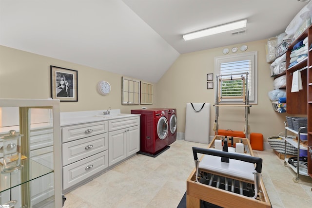 laundry room with cabinets, sink, and washing machine and dryer