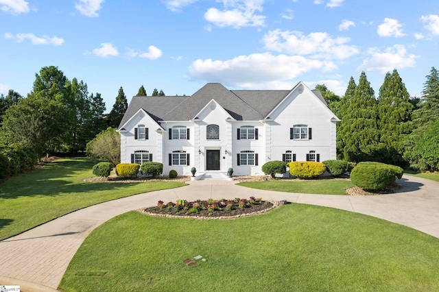 view of front of property with concrete driveway and a front yard