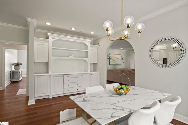 dining space featuring arched walkways, dark wood-style floors, an inviting chandelier, crown molding, and recessed lighting