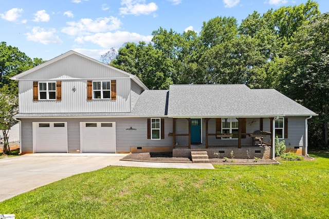 view of property with a front lawn, a garage, and covered porch