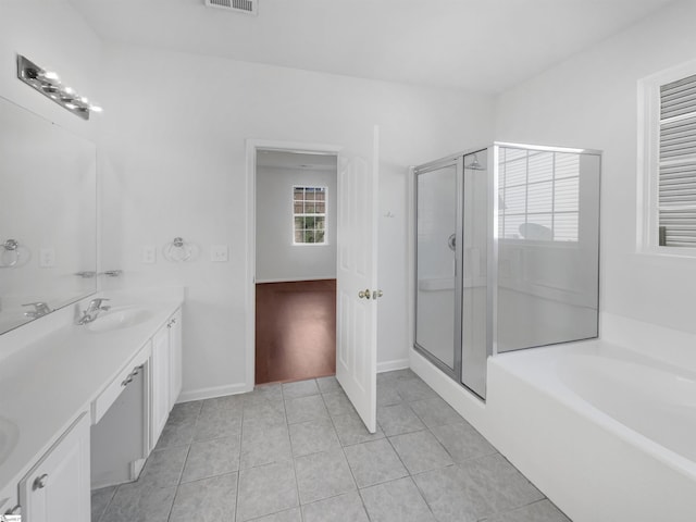 bathroom with tile patterned floors, vanity, and independent shower and bath