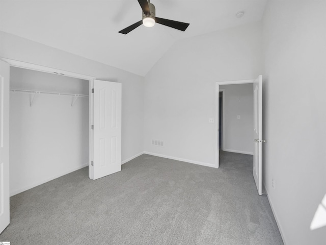 unfurnished bedroom featuring carpet flooring, ceiling fan, a closet, and lofted ceiling