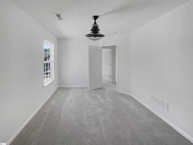 unfurnished room featuring light colored carpet