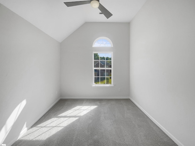 spare room featuring carpet, ceiling fan, and lofted ceiling