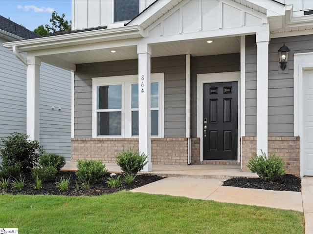 view of exterior entry with a porch