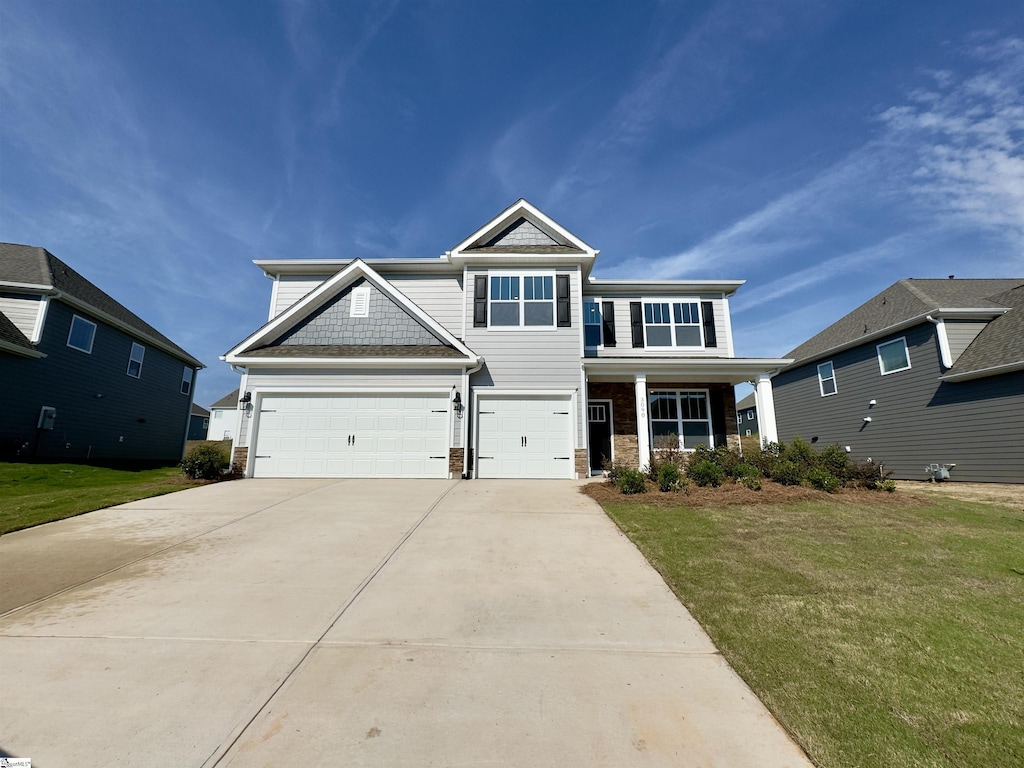 craftsman inspired home with a front yard and a garage