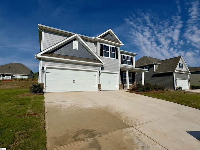 craftsman-style house featuring a front yard and a garage