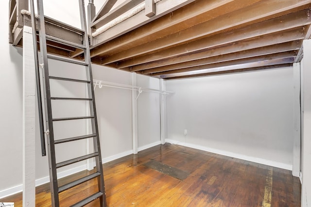 basement with hardwood / wood-style flooring