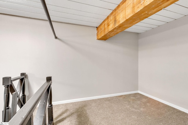 interior space with beam ceiling and carpet