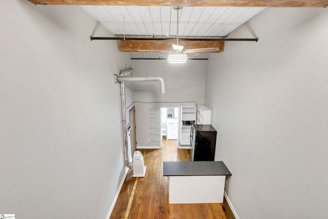 basement with wood-type flooring and ceiling fan