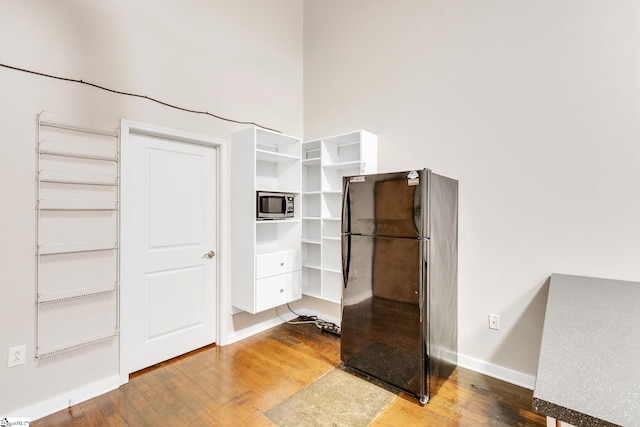 walk in closet with hardwood / wood-style floors