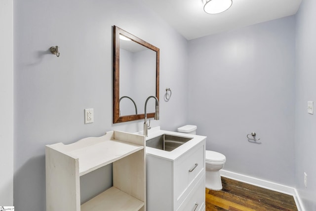 bathroom with vanity, wood-type flooring, and toilet