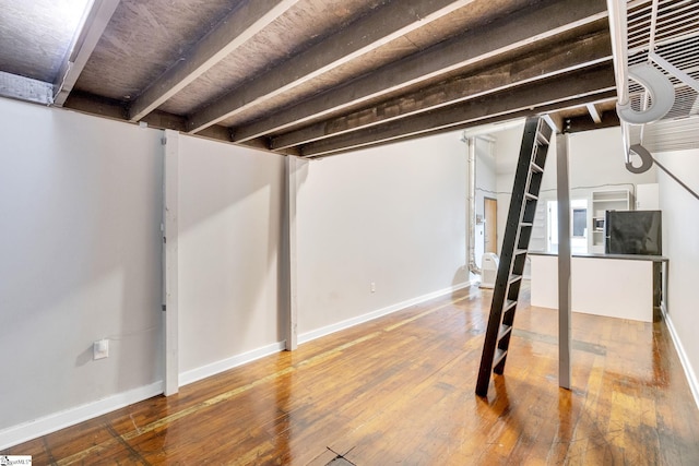 basement with hardwood / wood-style floors