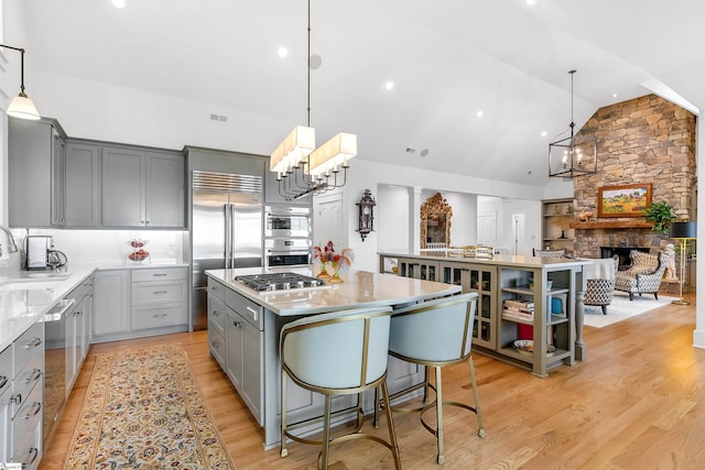 7 Drift Away Ln, Landrum, SC 29356 - kitchen with a large island, gray cabinets, an inviting chandelier, and appliances with stainless steel finishes
