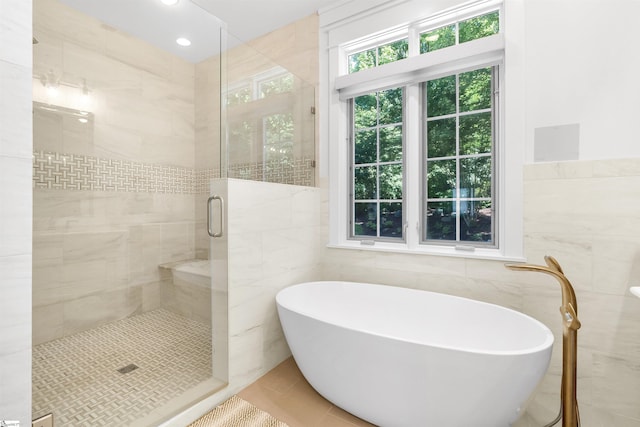 7 Drift Away Ln, Landrum, SC 29356 - full bathroom with a shower stall, a freestanding tub, tile patterned flooring, and tile walls