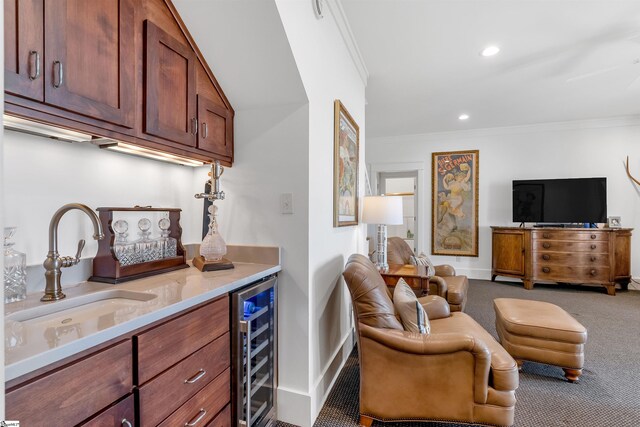 interior space featuring crown molding, light stone counters, wine cooler, sink, and carpet