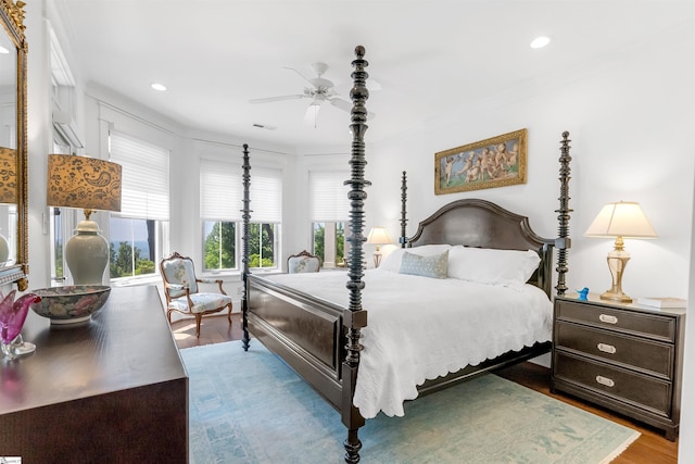 bedroom featuring ceiling fan, hardwood / wood-style floors, and ornamental molding