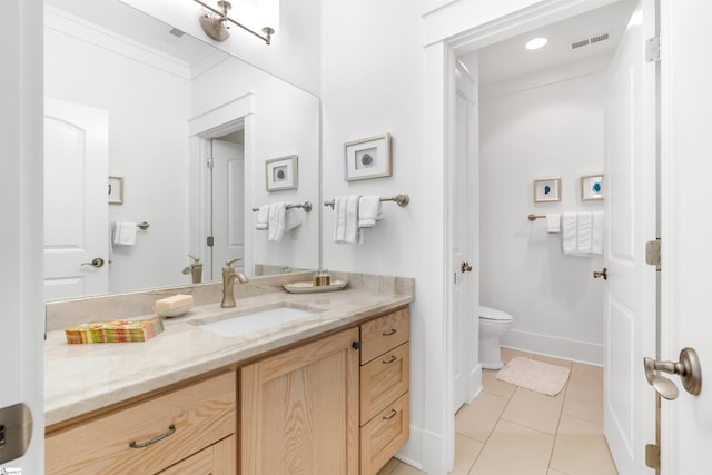 bathroom with tile floors, vanity, and toilet