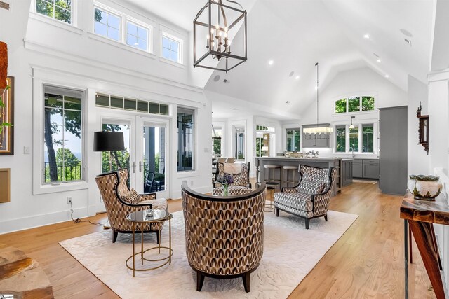 living room with high vaulted ceiling and a healthy amount of sunlight