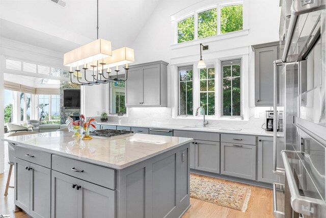 kitchen featuring a wealth of natural light, light hardwood / wood-style floors, and tasteful backsplash