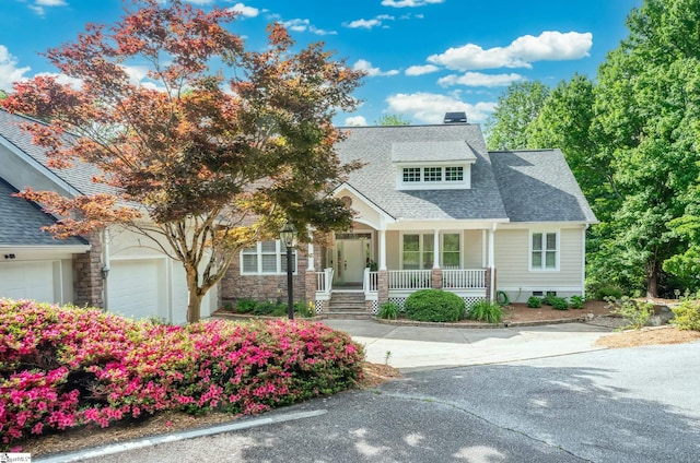 view of front of property with covered porch and a garage