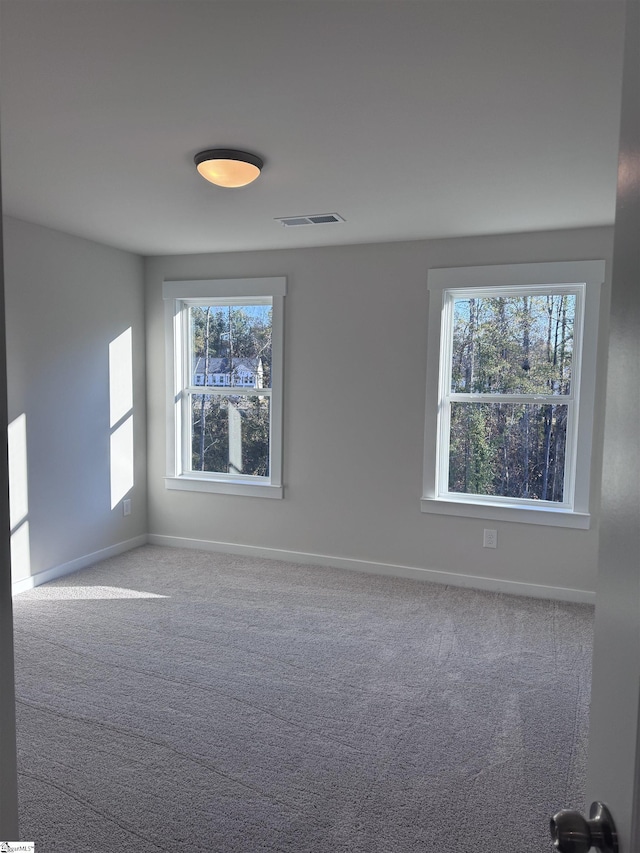 unfurnished room featuring carpet