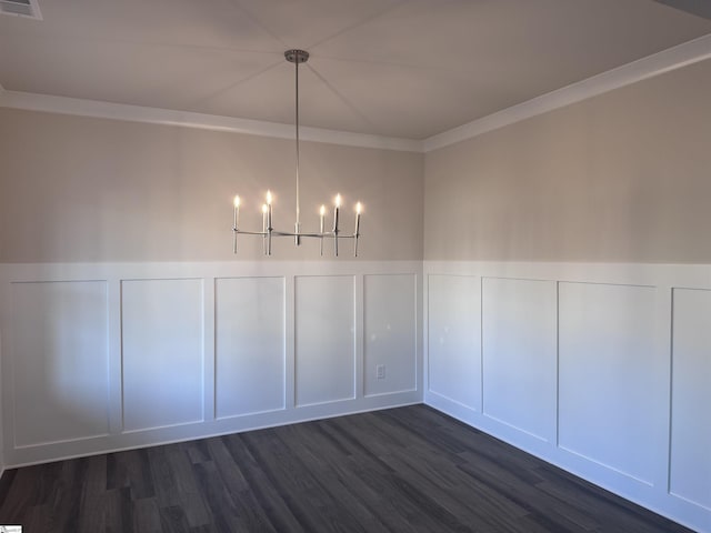 unfurnished dining area with crown molding, dark wood-type flooring, and a chandelier