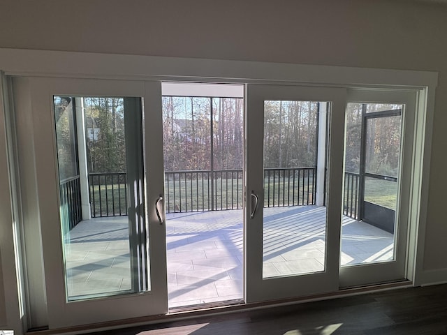 doorway with dark hardwood / wood-style flooring